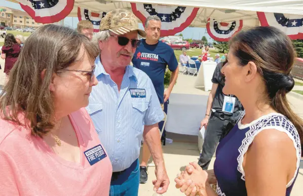  ?? TOM BEAUMONT/AP ?? Nikki Haley, right, talks with Bob and Kathy de Koning in Sioux County, Iowa. Haley, who could seek the Republican presidenti­al nomination in 2024, was the ambassador to the United Nations under former President Donald Trump.