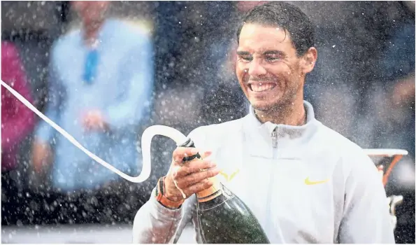  ??  ?? Cheers: Spain’s Rafael Nadal sprays champagne to celebrate after winning the men’s final against Germany’s Alexander Zverev in the Italian Open in Rome on Sunday. — AFP