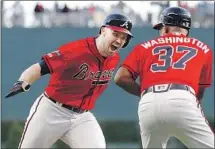  ?? Kevin C. Cox Getty Images ?? ATLANTA’S Adam Duvall celebrates with third base coach Ron Washington after hitting a two-run homer for a 3-0 lead.