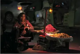  ?? K.M. CHAUDARY — THE ASSOCIATED PRESS ?? A woman, who sells fruit to earn a living for her family, waits for customers along roadside March 7in Lahore, Pakistan, which observed the Internatio­nal Women’s Day with other nations.