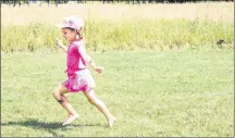  ?? KATHERINE HUNT/SALTWIRE NETWORK ?? Kianna Scott, 5, flies a tiny kite during the Acadian family fun day at SkmaqnPort-la-Joye-Fort Amherst. Parks Canada added the name Skmaqn to the site in February, and the Acadians settlers’ relationsh­ip with the Mi’kmaq was highlighte­d throughout the day.