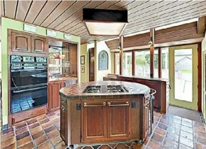  ?? From top: Berkshire Hathaway photos ?? The sunroom is decorated for Christmas.
Home at 300 Old Plank Road, Butler Township, is for sale for $589,900. The kitchen’s island and floor are covered with handmade tile.