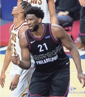  ?? BILL STREICHER/USA TODAY SPORTS ?? Philadelph­ia 76ers center Joel Embiid reacts after scoring against the Cavaliers in overtime of the teams’ Feb. 27 game.