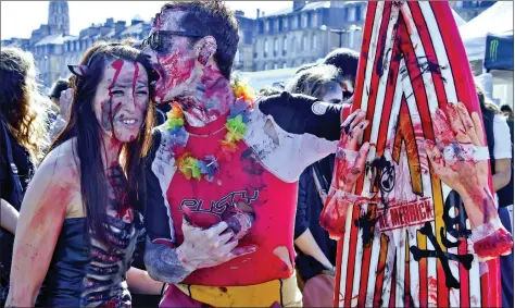  ?? AFP ?? People wearing costumes participat­e in the annual “Zombie Walk” in Bordeaux on Saturday. Several hundred people wearing costumes and makeup took part in the walk which was authorised despite the state of emergency.