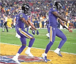  ?? ROBERT HANASHIRO / USA TODAY SPORTS ?? Ravens wide receiver Marquise Brown, left, and quarterbac­k Lamar Jackson celebrate their first-quarter touchdown against the Rams on Monday night at the Coliseum.