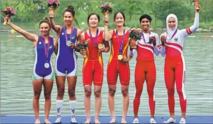  ?? WEI XIAOHAO / CHINA DAILY ?? Winners of the women’s lightweigh­t double sculls rowing event pose for a group photo on Sept 24 during the awards ceremony at the 19th Asian Games in Hangzhou, Zhejiang province. Chinese duo Zou Jiaqi (third from left) and Qiu Xiuping (third from right) clinched the first gold medal of the Games with a time of 7 minutes and 6.78 seconds in the final race in this rowing category. The teams from Uzbekistan and Indonesia won silver and bronze, respective­ly.