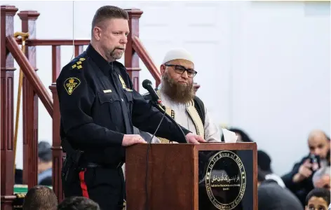  ?? MATT SMITH ?? Saskatoon Chief of Police Troy Cooper and Imam Illyas speak to members of Saskatoon’s Muslim community on Friday.