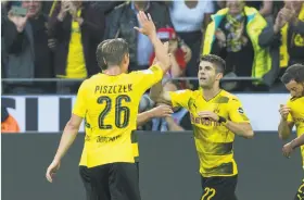  ?? Marius Becker / Associated Press ?? U.S. national team forward Christian Pulisic (22) gave his Bundesliga club Borussia Dortmund the early lead in the German Supercup.