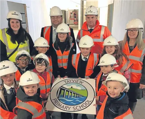  ??  ?? PUPILS who will attend the new Tayview Primary in Dundee got a look behind the scenes at the £13.2 million constructi­on project.The children, who currently attend Gowriehill and Hillside primaries, helped choose the name of the new school and assisted with ideas for its logo design. They will move into the