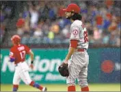  ?? Mike Stone Associated Press ?? THE ANGELS’ Noe Ramirez reacts after giving up a three-run homer to the Rangers’ Rougned Odor.