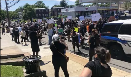  ?? KATHLEEN E. CAREY - MEDIANEWS GROUP ?? Protesters march past Yeadon Borough Hall on Sunday.