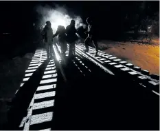  ?? JOHN WOODS/THE CANADIAN PRESS ?? Early morning on Feb. 26, eight migrants from Somalia cross into Canada illegally from the U.S. by walking down this train track into Emerson, Man. Many African asylum-seekers who end up in Canada face an arduous, months-long journey through thousands...