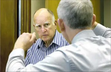  ?? Rich Pedroncell­i Associated Press ?? GOV. JERRY BROWN discusses a bill with Tom Dyer, his chief deputy legislativ­e affairs secretary. Brown and Donald Trump share at least one view: High-speed rail is needed for America’s transporta­tion future.