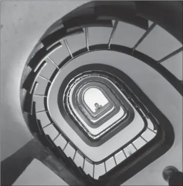  ?? PAUL CHILD — THE SCHLESINGE­R LIBRARY, RADCLIFFE INSTITUTE, HARVARD UNIVERSITY VIA AP ?? In this 1955 photo provided by Thames and Hudson, is Julia Child looking down a stairway in France that is part of the exhibit, “France is a Feast - The Photograph­ic Journey of Paul and Julia Child,” at the Napa Valley Museum in Yountville The exhibit...