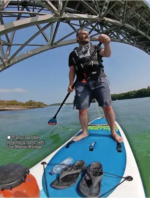  ?? ?? ● Tudur paddle boarding, and, left, the Menai Bridge