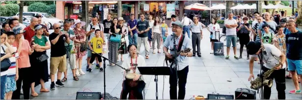  ?? PHOTOS PROVIDED TO CHINA DAILY ?? Yu Hanyi and his wife Liu Liyuan are two of Shanghai’s 123 licensed street performers.