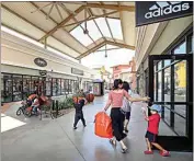  ?? CALIFORNIA­N FILE ?? People shop at the Outlets at Tejon in this August 2018 file photo.