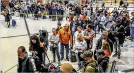  ?? JOHN SPINK / JSPINK@AJC.COM ?? Hartsfield-Jackson officials advised travelers to get to the terminal three hours before their flights to allow enough time to clear security. Delta said its employees are helping to manage security lines and answer customers’ questions.