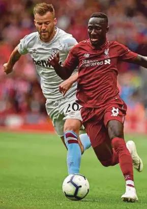  ?? AFP PIC ?? Liverpool’s Naby Keita (right) vies for the ball with West Ham United’s Andriy Yarmolenko at Anfield on Sunday.