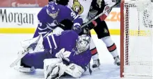  ?? FRANK GUNN/THE CANADIAN PRESS ?? Toronto Maple Leafs’ goalie Frederik Andersen covers the puck as Maple Leafs left wing Colin Greening, Ottawa Senators centre Tom Pyatt and Senators left wing Max McCormick battle during first period NHL pre-season action, in Toronto last week.