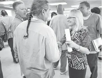  ?? Dan Rosenstrau­ch / Bay Area News Group/TNS ?? Collette Carroll greets inmates at San Quentin State Prison participat­ing in a program that prepares and supports men through the transition from prison to freedom, called California Reentry Institute. The program has had a zero percent recidivism rate...