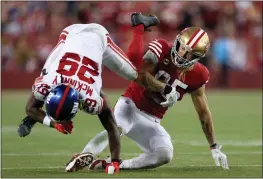  ?? EZRA SHAW — GETTY IMAGES ?? The Giants' Xavier McKinney (29) tackles the 49ers' George Kittle (85) during the third quarter of Thursday's game at Levi's Stadium in Santa Clara.