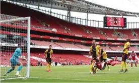  ??  ?? Ben Foster and his Watford defence can only watch as Pierre-Emerick Aubameyang makes it 3-0 to Arsenal at the Emirates. Photograph: Julian Finney/PA