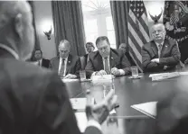  ?? Oliver Contreras / Tribune News Service ?? President Donald Trump listens as Attorney General Jeff Sessions (back to camera) speaks during a Cabinet meeting in the White House.