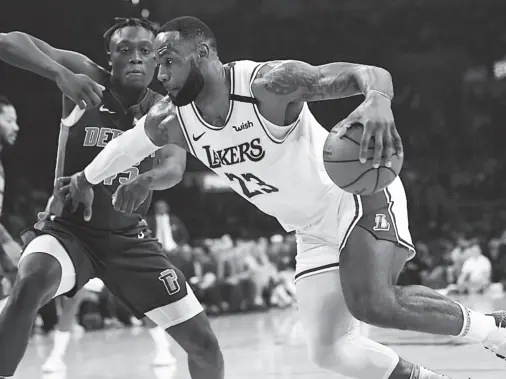  ??  ?? LOS ANGELES Lakers forward LeBron James, right, drives past Detroit Pistons forward Sekou Doumbouya during the first half of an NBA basketball game Sunday, Jan. 5, 2020, in Los Angeles. (AP Photo/Mark J. Terrill)