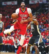  ?? AP/GERALD HERBERT ?? Pelicans forward Anthony Davis (23) is fouled as he drives to the basket by Warriors forward Kevon Looney on Friday in New Orleans.