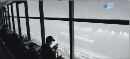  ?? Phelan M. Ebenhack The Associated Press ?? A downpour Sunday, as viewed from the press box at Daytona Internatio­nal Speedway in Daytona Beach, Fla., forces a postponeme­nt of the Daytona 500 to Monday.