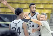  ?? Cliff Grassmick / Staff Photograph­er ?? Colorado assistant coach Bill Grier, right, works with Dallas Walton during a practice Oct. 16.