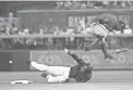  ?? CHERYL EVANS/THE REPUBLIC ?? The Diamondbac­ks’ Nick Ahmed slides under Washington Nationals infielder Howie Kendrick and into second base during Saturday’s game at Chase Field.