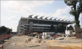  ?? Francois Mori / Associated Press ?? The Philippe-Chatrier tennis court with its retractabl­e roof is pictured from the constructi­on site access in Paris on Sunday as the Roland Garros tournament is posponed.