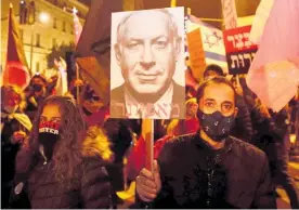  ?? Photo / AP ?? Israeli protesters hold a sign showing Israeli Prime Minister Benjamin Netanyahu at a demonstrat­ion in Jerusalem.