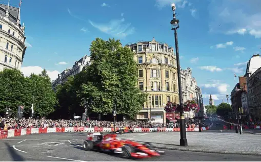  ?? – AP ?? Streets of fire: Ferrari’s Sebastian Vettel drives into Trafalgar Square from Whitehall during the F1 Live event in London on Wednesday.