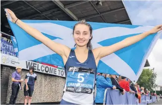  ??  ?? Winner Coirilidh Cook celebrates after her victory in 80m hurdles. Photo by Bobby Gavin