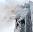 ??  ?? Flames and thick smoke could be seen coming from the 50th-floor apartment