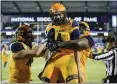  ?? BRANDON WADE — THE ASSOCIATED PRESS ?? Kent State quarterbac­k Dustin Crum is congratula­ted by teammates after scoring a touchdown in Friday’s Frisco Bowl victory over Utah State.