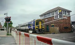  ?? NORTHERN ?? A Class 158 passes the signalbox and crossing at Bedlington South in early August 2023, with a special working for Northern along the route of the Northumber­land Line.