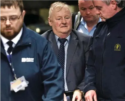  ?? ?? Convict: Bill Kenneally leaves the Commission of Investigat­ion in handcuffs in Dublin yesterday