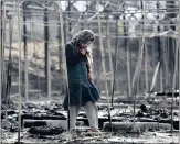  ?? PICTURE: REUTERS ?? A migrant stands among the remains of a burnt tent at the Moria migrant camp on the Greek island of Lesbo