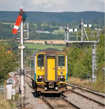  ??  ?? Leaving Craven Arms on September 11 2012, the driver of 153303 continues under the authority of CA2 signal. This semaphore remains in use, but the bracket holding CA 23 and CA8 was removed earlier this year when the crossover for the Central Wales Line was moved to the south end of the station.