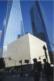  ?? AP PHOTO/BEBETO MATTHEWS ?? A box-shaped building, shown Wednesday, center, wrapped in translucen­t marble panels, is home to the new Perelman Performing Arts Center theater complex on the grounds of the World Trade Center in New York.