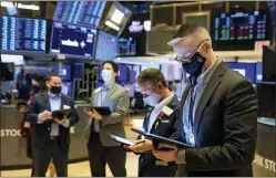  ?? COLIN ZIEMER — NEW YORK STOCK EXCHANGE VIA AP ?? Traders work on the New York Stock Exchange floor Wednesday.