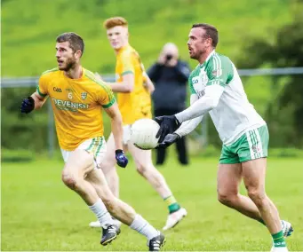  ??  ?? Eoin McHugh of St Molaise Gaels sets up an attack as Tourlestra­ne’s Adrian McIntyre defends.