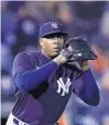  ?? CARLOS OSORIO/AP ?? Yankees reliever Aroldis Chapman, shown pitching in March, has the coronaviru­s but is “doing well,” his manager Aaron Boone says.