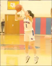  ?? Photo by Becky Polaski ?? Molly Hanslovan, 2, puts up the three-point shot that gave the Lady Dutch the lead for good in their season opener and sparked a 23-point run to end the first half.