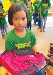  ?? ?? STUDENT ROSEMARIE receiving her new backpacks, school supplies, loot bags, and hygiene kits.