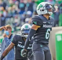  ?? AP PHOTO/ SHOLTEN SINGER ?? Marshall’s Micah Abraham celebrates after a Middle Tennessee State turnover during the Thundering Herd’s home win last Saturday.